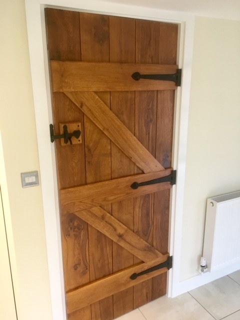 Existing timber ledged door inside a finished room